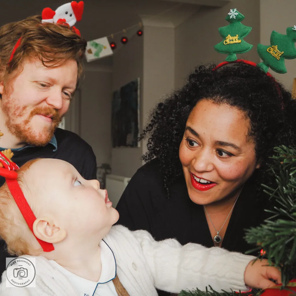 Mum, Dad and baby wearing Christmas headbands