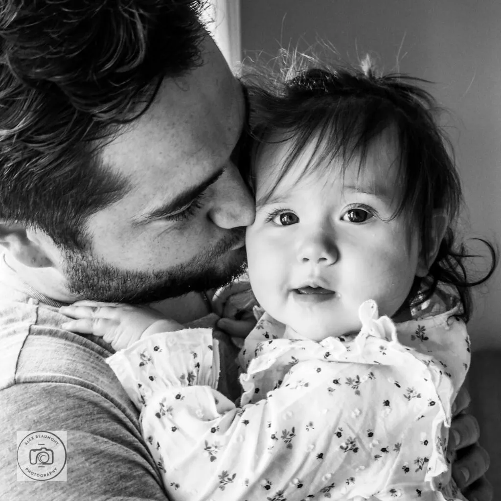 Dad holding toddler daughter