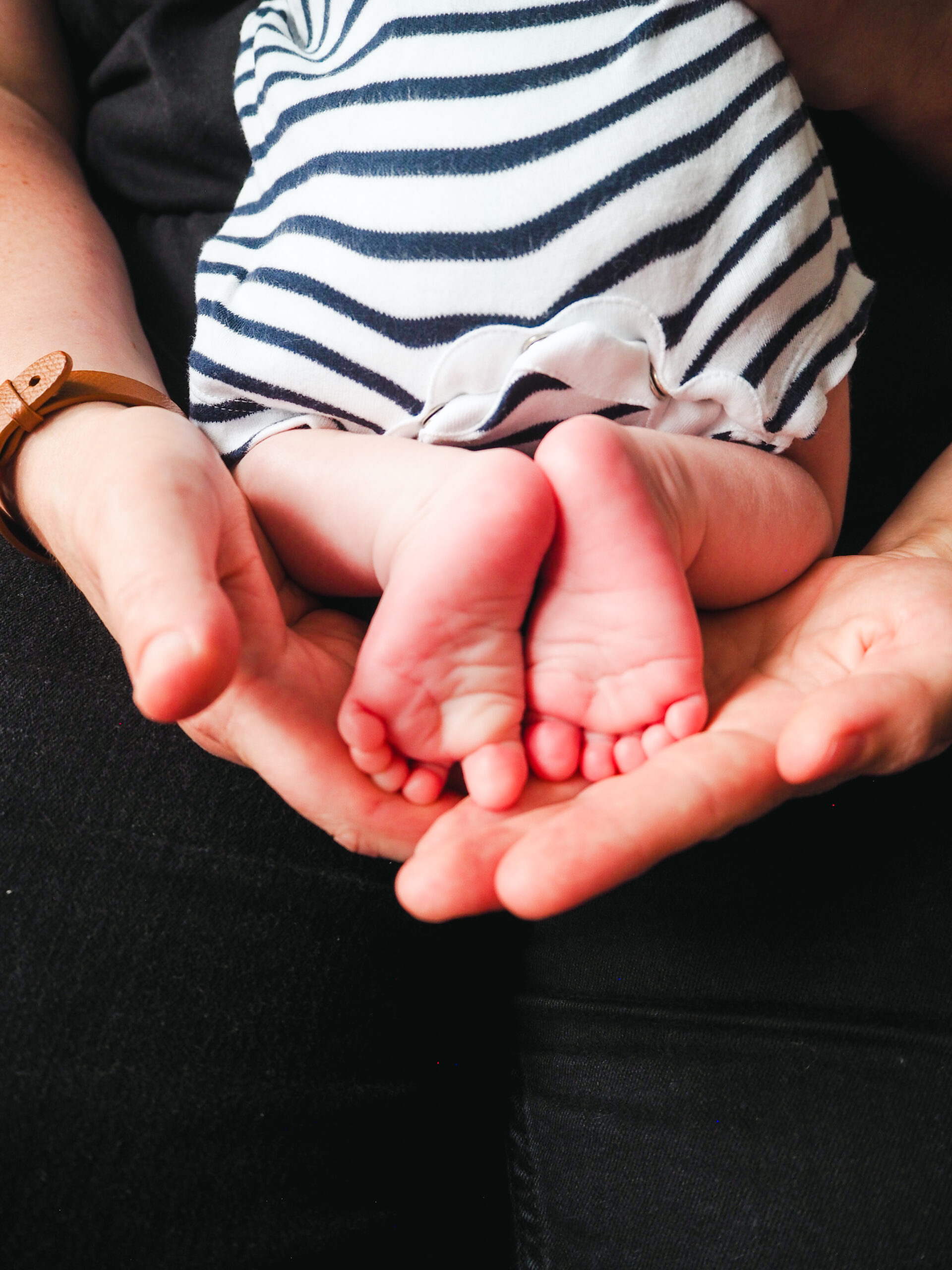 Newborn feet in hands